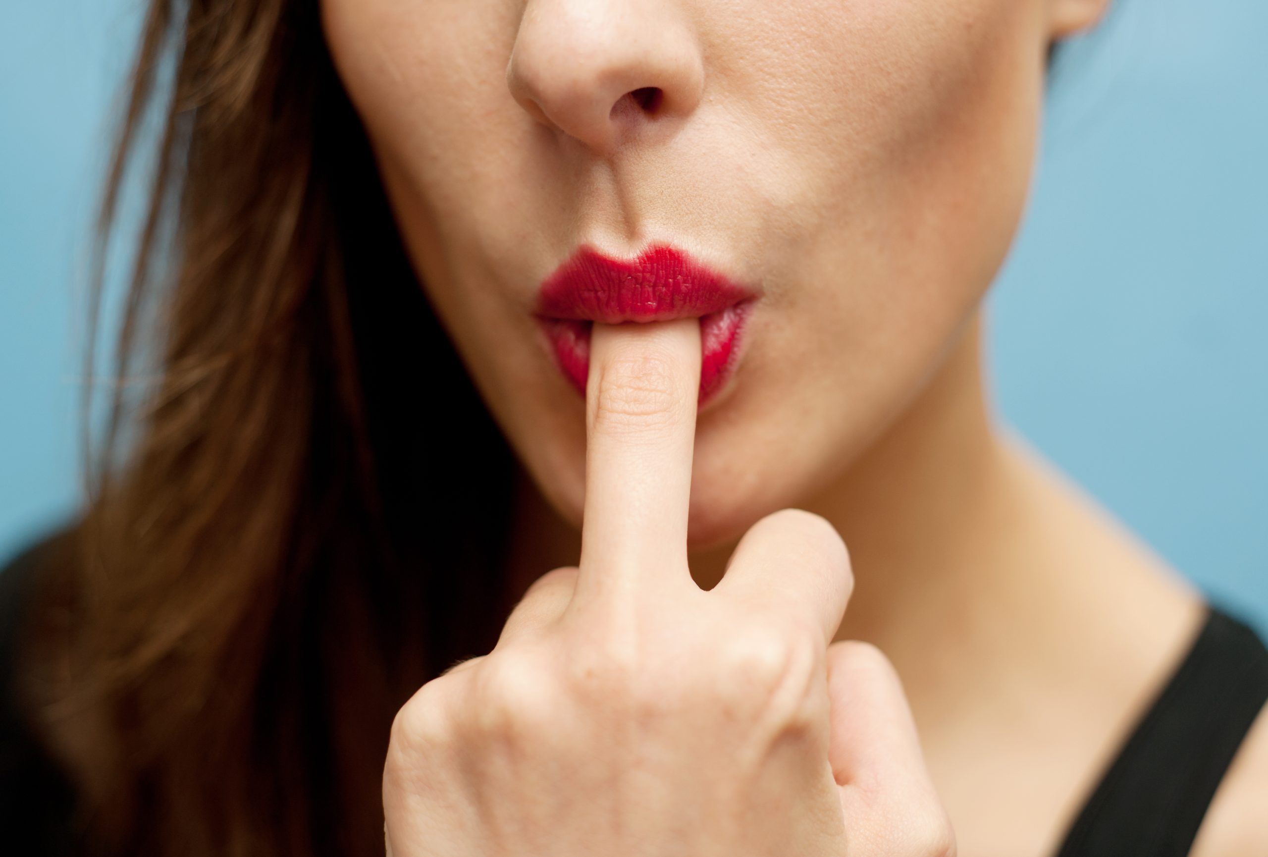 A woman sucks her middle finger directed at her pathetic cuck husband.