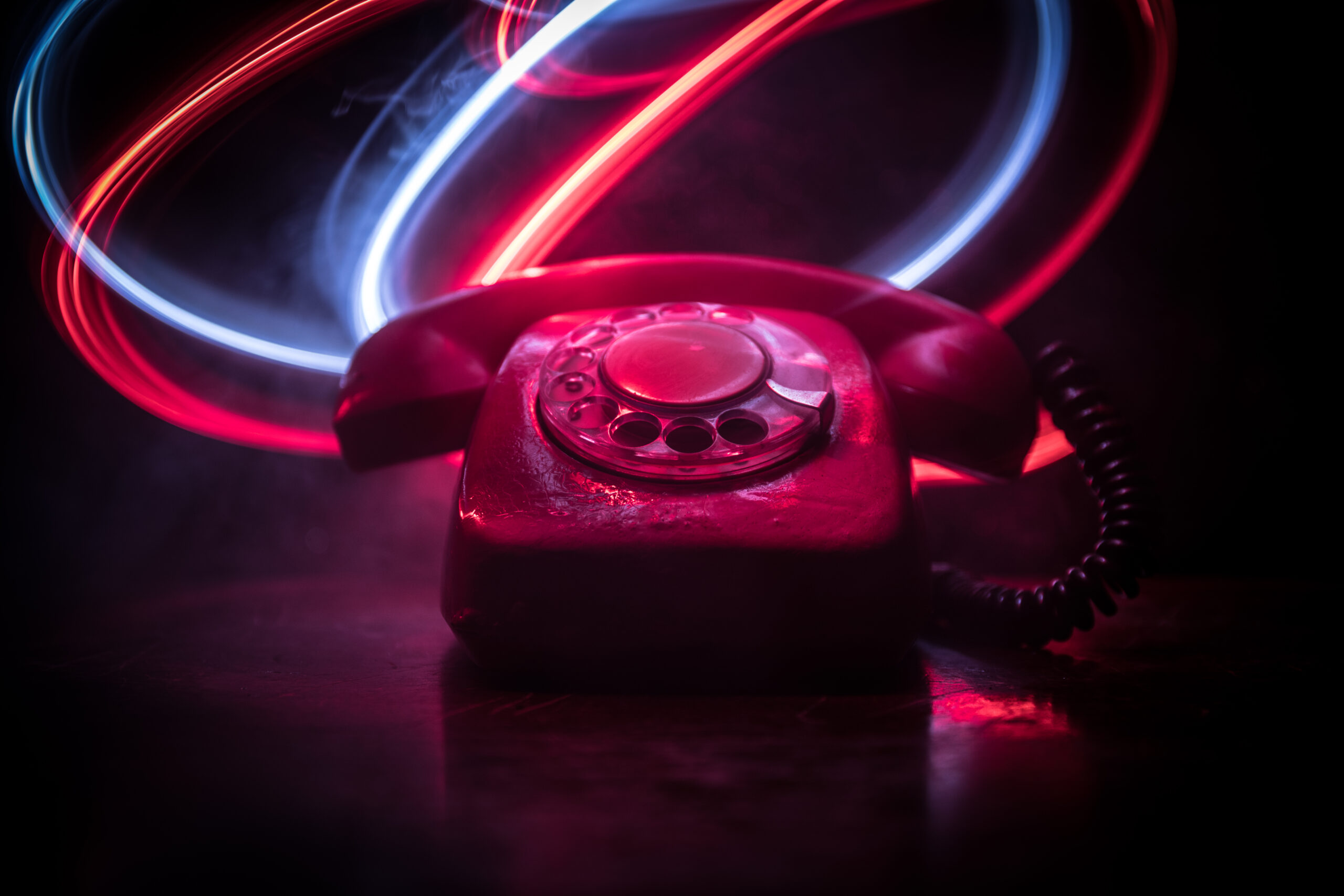 Katrina phone sex operator red phone sitting on a table with neon background